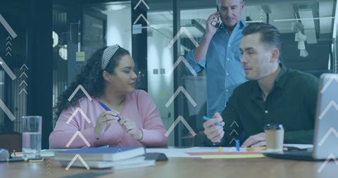 Diverse Team Collaborating in Office with Data Graphics Overlay