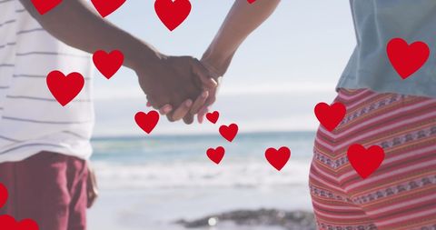 Romantic Couple Holding Hands with Heart Motif on Beach