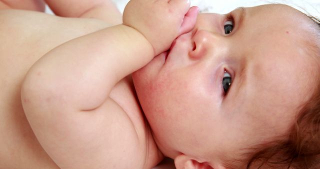 Adorable Baby Lying Down Sucking Thumb Close Up - Download Free Stock Images Pikwizard.com