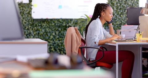 Professional Woman Working in Modern Green Office Space - Download Free Stock Images Pikwizard.com