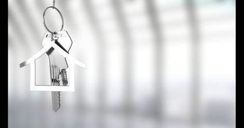 House-shaped metallic keychain with keys in modern interior