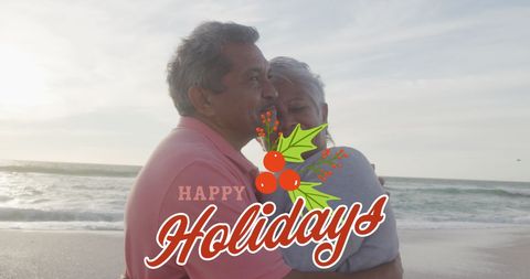Happy Senior Couple Embracing on Beach at Holiday Season