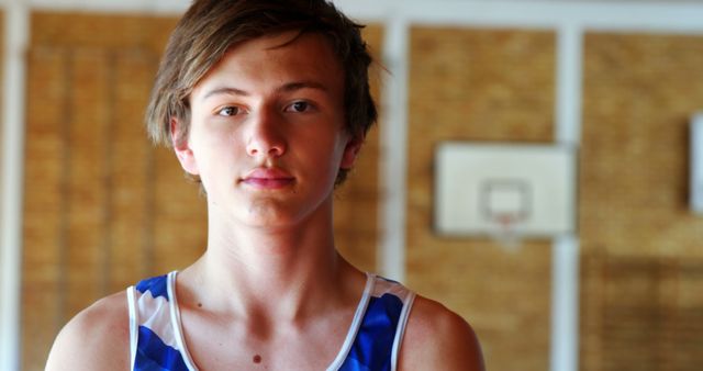 Teenage Boy in Basketball Jersey in Gym - Download Free Stock Images Pikwizard.com