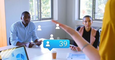 Presenting business team analyzing social notifications and data dashboards on tablets