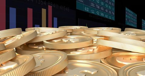 Stacks of Gold Coins with Financial Data Background