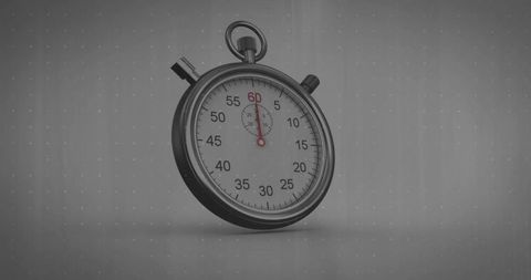 Vintage chrome stopwatch tilted on gray dotted background, red second hand and glass dial