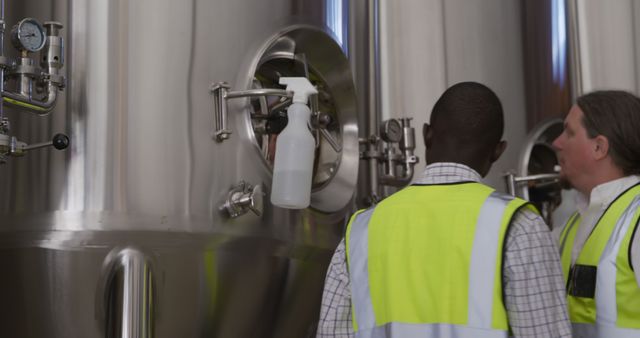 Workers in Hi-Vis Vests Inspecting Industrial Equipment - Download Free Stock Images Pikwizard.com