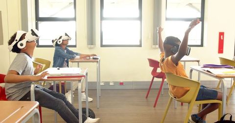 Diverse students engaged with virtual reality in classroom setting