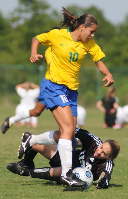 Perfect for sports articles, athletic event promotions, and blogs on women's sports. Captures the intensity and action of a competitive soccer game, showcasing the skills and determination of female soccer players on the field.