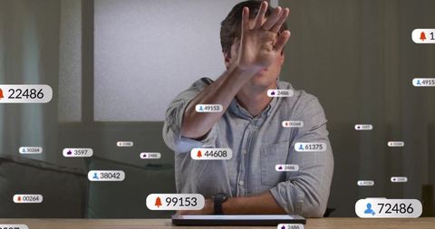 Man blocking notifications showing digital overload in home office