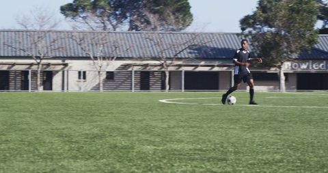Athlete in Yellow Jersey Engaging in Dynamic Soccer Play
