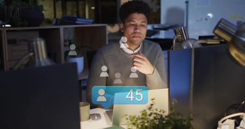 Working late in open-plan office tracking social followers with 45 followers overlay