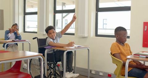 Diverse Students Learning with Engaged Wheelchair User in Modern Classroom