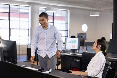 Diverse Colleagues Engaging in Lively Office Interaction