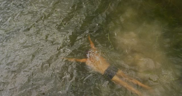 Person Enjoying a Swim in Natural River Waters - Download Free Stock Photos Pikwizard.com
