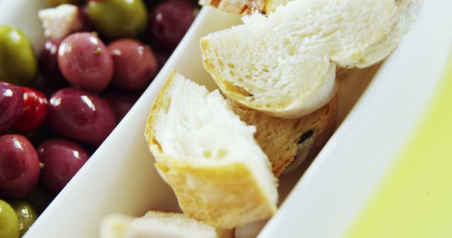 Close-Up of Fresh Bread and Olives in a White Serving Tray - Download Free Stock Images Pikwizard.com