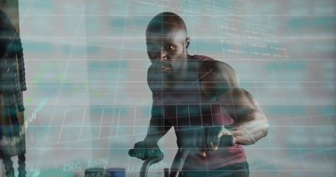 Pedaling muscular man leaning forward gripping bike handles with fitness data overlays