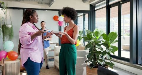 Colleagues engaging conversation after office celebration