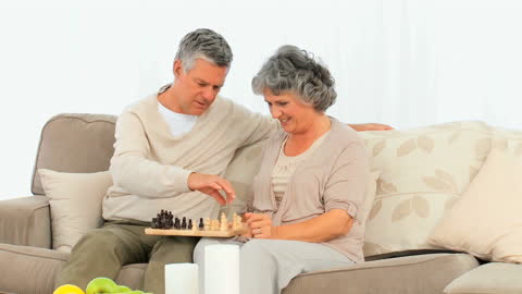Senior Couple Enjoying a Game of Chess at Home