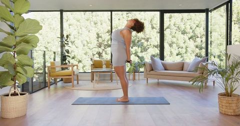 African American Woman Practicing Yoga in Modern Home Interior