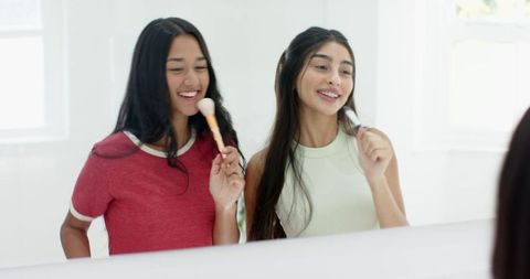 Diverse Female Friends Having Fun with Makeup at Home