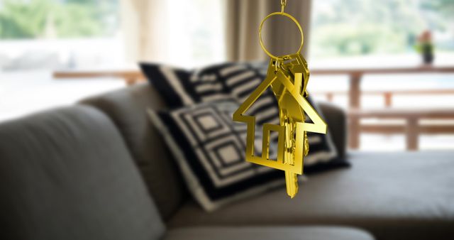 Gold House Key and Key Ring with Modern Living Room in Background - Download Free Stock Images Pikwizard.com