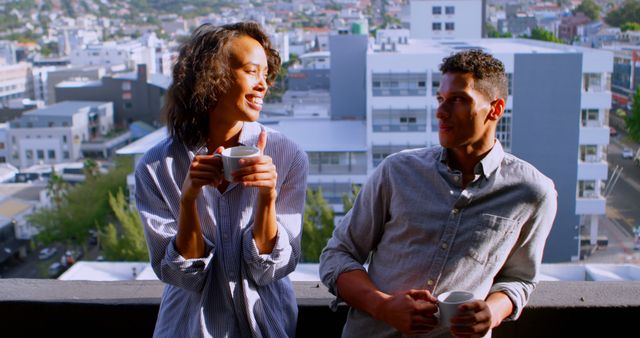 Couple Enjoying Coffee on Balcony Overlooking Cityscape - Download Free Stock Images Pikwizard.com