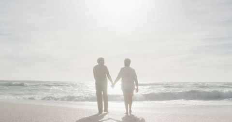 Senior Couple Walking on Tranquil Beach at Sunset - Download Free Stock Images Pikwizard.com
