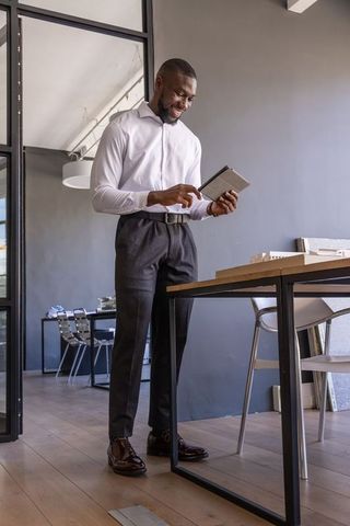 African american male architect reviewing project plans on tablet