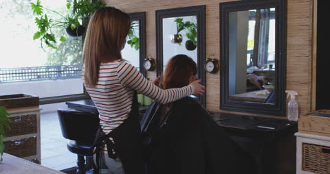Hairdresser Wearing Mask Works with Client in Modern Salon