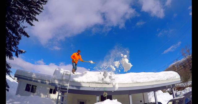 Caucasian man clearing snow from roof of the house with copy space - Download Free Stock Photos Pikwizard.com