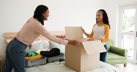 Women packing for travel at home preparing for vacation
