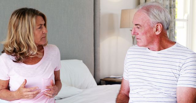 Senior Couple Having Serious Conversation in Bedroom - Download Free Stock Images Pikwizard.com