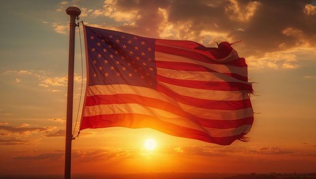 American flag glowing against warm sunset horizon