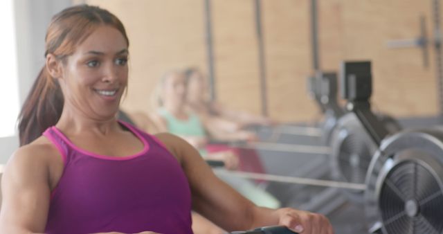 Woman Rowing on Indoor Machine at Fitness Gym - Download Free Stock Images Pikwizard.com