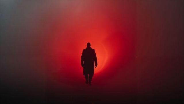 Mysterious Silhouette Walking Through Red Mist Tunnel