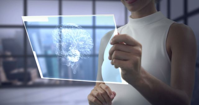 Woman holding holographic display analyzing brain projection, showcasing futuristic technology in modern office. Ideal for illustrating concepts in neuroscience, innovation, and digital advancements, suitable for use in tech, scientific research, and future-forward business contexts.