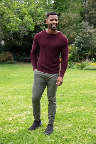 Man Standing on Lawn in Greenery, Wearing Casual Outfit, Wellness and Relaxation