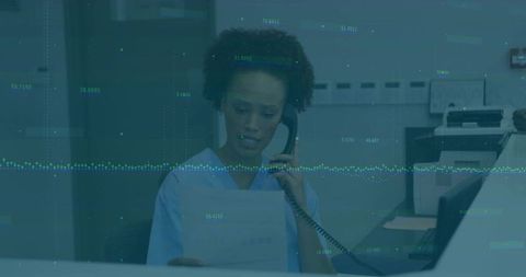 Medical professional communicating at clinic reception desk