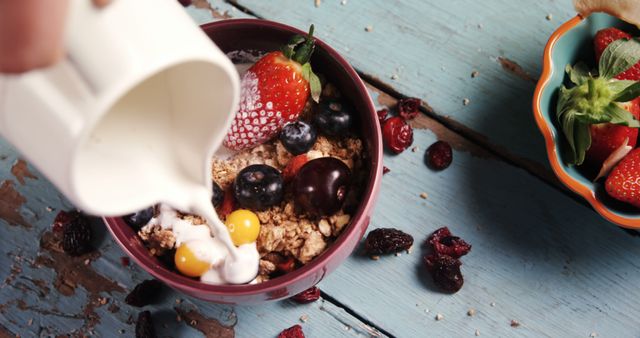 Hand Pouring Milk into Healthy Breakfast Bowl with Fresh Fruits and Granola - Download Free Stock Images Pikwizard.com