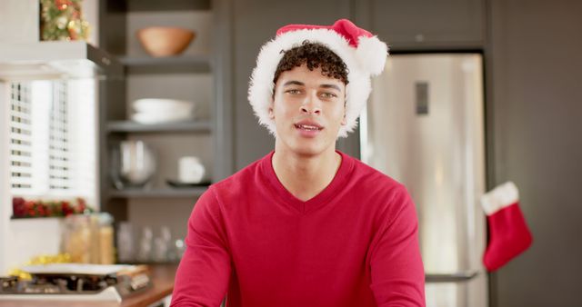 Smiling Young Male in Christmas Attire in Modern Kitchen - Download Free Stock Images Pikwizard.com