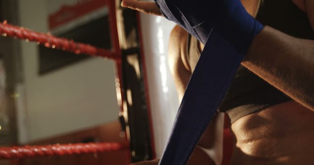 Female Boxer Wrapping Hands with Blue Bandages Before Training - Download Free Stock Images Pikwizard.com