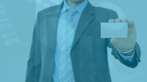 Businessman Holding Blank Card Over Data Graphics