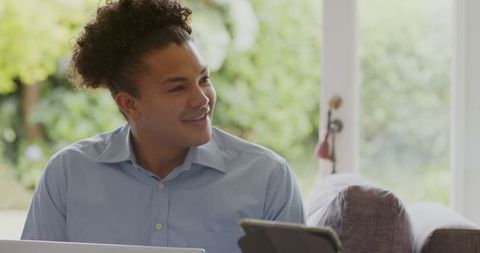Couple smiling and engaging with gadgets at home