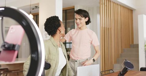 Collaborating on Content Creation in Bright Home Studio with Ring Light and Microphone