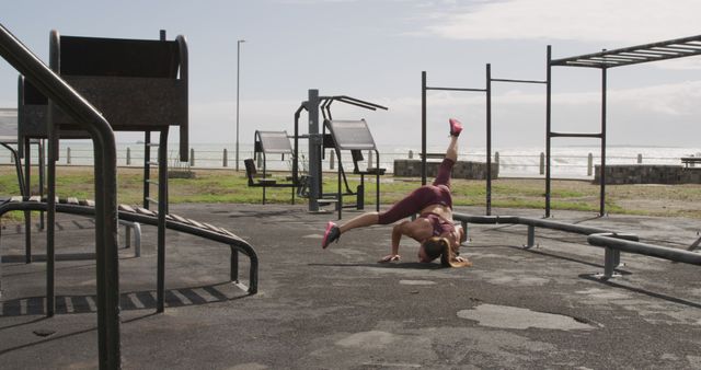 Woman Practicing Gymnastics in Outdoor Gym by Ocean - Download Free Stock Images Pikwizard.com