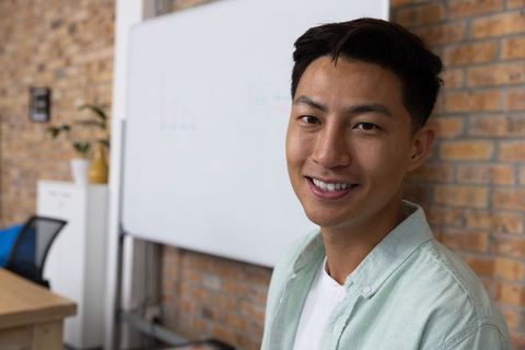 Confident Young Professional Smiling in Modern Office Environment