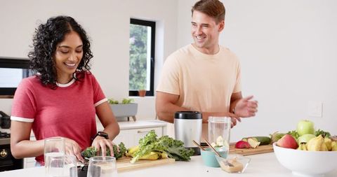 Diverse Couple Joyfully Preparing Healthy Smoothies Together
