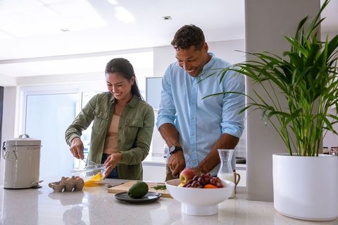 Diverse Couple Preparing Meal Together in Modern Kitchen