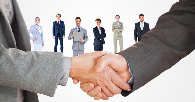 Cropped image of business people doing handshake with employees in background - Download Free Stock Photos Pikwizard.com